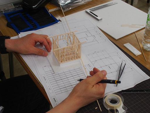 家の設計図を組み立てる様子